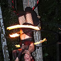 Upside down fire hula hooping.